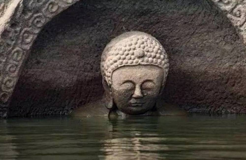 Sunken, 600-Year-Old Buddha Emerges from Water in China